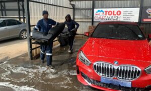 Expert staff at Tolo Car Clinic in Cosmo City conducting a Full-House Valet on a red BMW.
