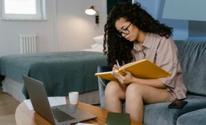 A woman completing an online CompTIA Cloud+ CV0-002 course from Skill Up