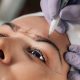 A stock photo of a woman having microblading done