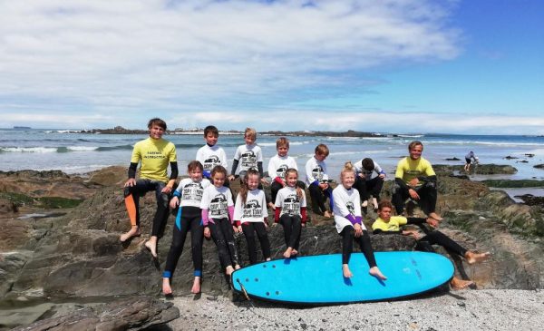 A group of people trying SUPing at Cape Town Surf School in Bloubergstrand