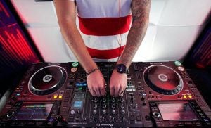 A DJ playing music at his table