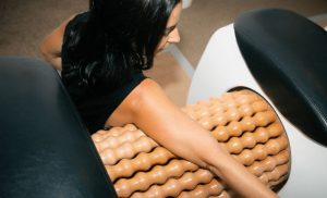 A stock photo of a woman using a lymph drainage massage machine