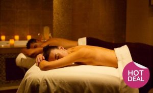 A stock image of a couple enjoying a massage at the spa