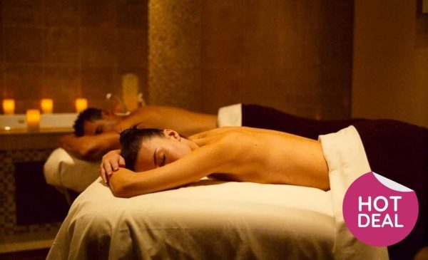 A stock image of a couple enjoying a massage at the spa