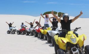 A goup of people enjoying a quad-biking experience from Quadzilla Adventures at Atlantis Dunes