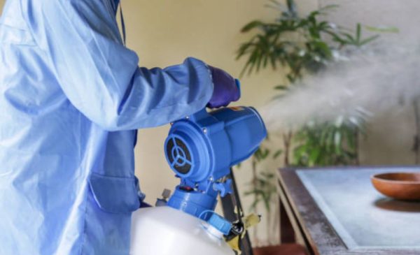 A stock photo of someone doing a fumigation session in an apartment