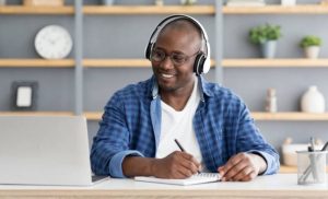 A stock photo of a man completing an online course on his laptop