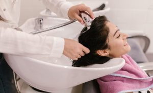 A stock photo of a woman having her hair washed in a hair salon