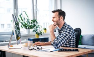 A stock photo of a man working on his laptop