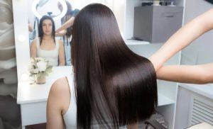 A stock photo of a woman receiving a Brazilian blowout