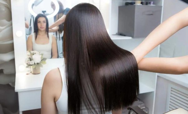 A stock photo of a woman receiving a Brazilian blowout