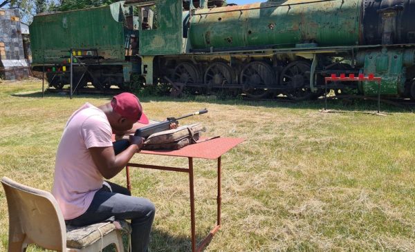 A man trying air pistol shooting at Horse Riding Adventure in Rayton