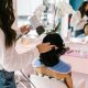 A stock photo of a woman having her hair done at a hair salon