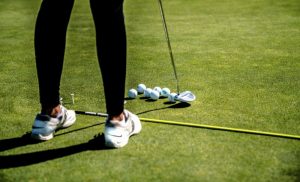 A stock photo of a person playing golf on a golf course