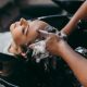 A stock photo of a woman getting her hair washed at the hair salon