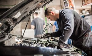 A stock photo of a man servicing a car