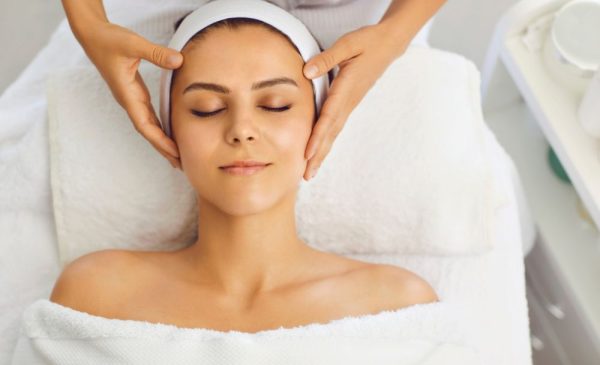 A stock photo of a woman getting a head massage at the spa